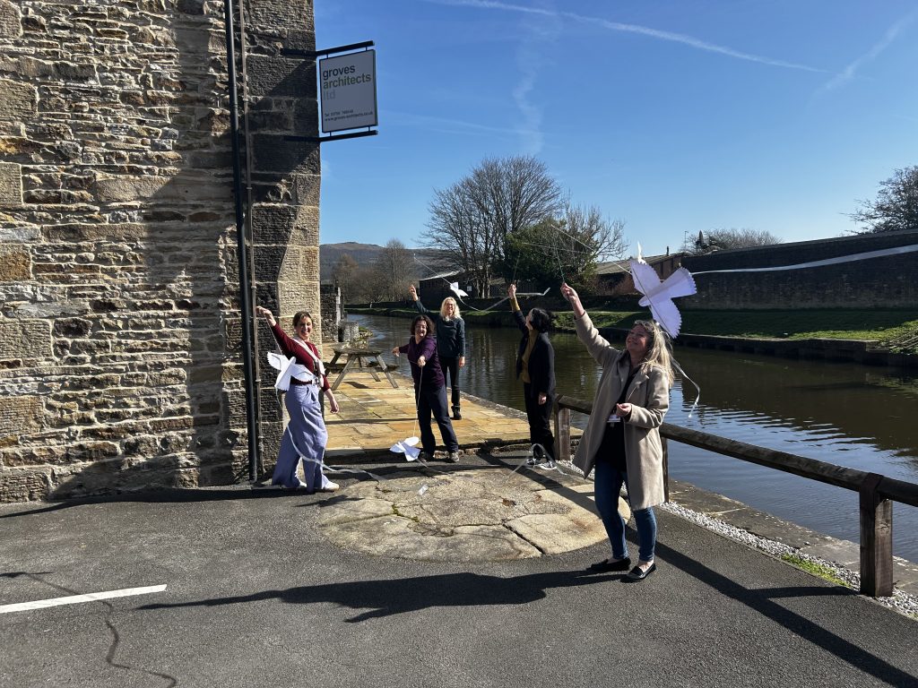 People flying hand crafted kestrel kites